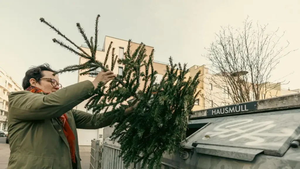 church member throwing away old christmas decorations